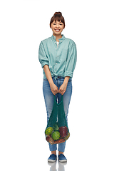 Image showing happy asian woman with food in reusable string bag