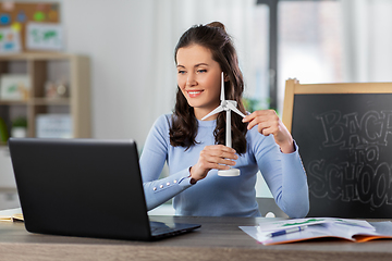 Image showing teacher with laptop and windmill has online class