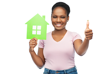 Image showing smiling african american woman holding green house