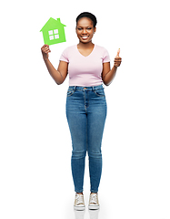 Image showing smiling african american woman holding green house