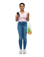 Image showing woman with smartphone and food in string bag