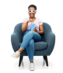 Image showing woman in 3d movie glasses eating popcorn in chair