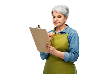 Image showing senior woman in garden apron with clipboard