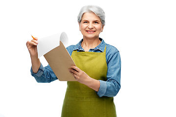 Image showing smiling old woman in garden apron with clipboard