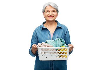 Image showing smiling senior woman with laundry basket