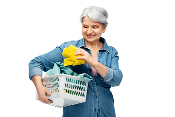 Image showing smiling senior woman with laundry basket