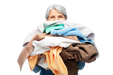 Image showing senior woman with heap of bath towels