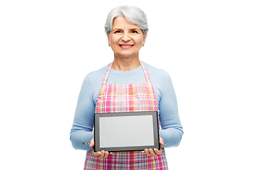 Image showing smiling senior woman in apron with tablet computer