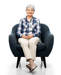 Image showing smiling senior woman sitting in modern armchair