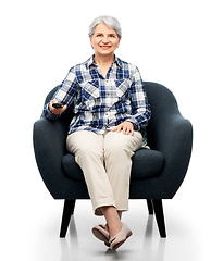 Image showing happy senior woman watching tv sitting in armchair