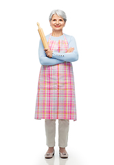 Image showing smiling senior woman in apron with rolling pin