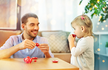 Image showing father and daughter playing tea party at home