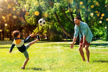 Image showing father with little son playing soccer at park