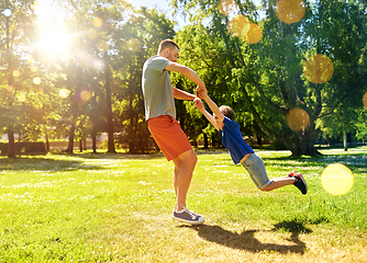 Image showing happy father with son playing in summer park