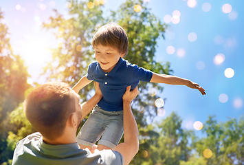 Image showing happy father with son playing in summer park