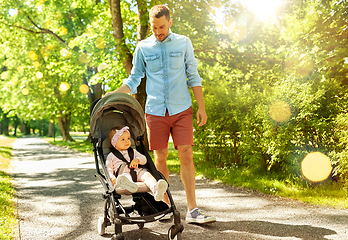 Image showing happy father with child in stroller at summer park