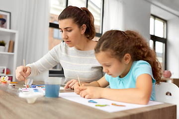 Image showing mother with little daughter drawing at home