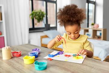 Image showing little girl with modeling clay playing at home