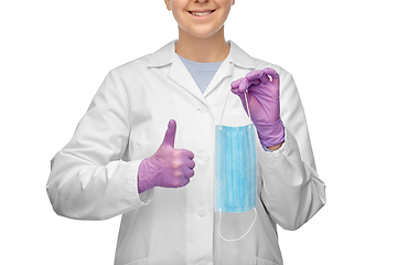 Image showing female doctor with medical mask showing thumbs up