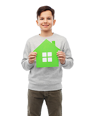 Image showing smiling boy holding green house icon