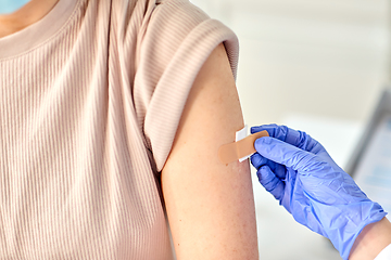 Image showing close up of doctor attaching patch to patient