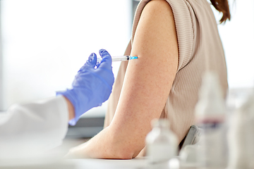 Image showing close up of hand with syringe vaccinating patient