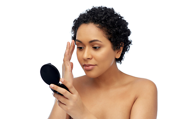 Image showing african american woman looking to mirror