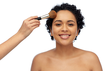 Image showing happy woman and hand of make up artist with brush