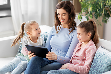 Image showing happy mother and daughters with tablet pc at home