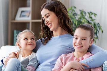 Image showing happy smiling mother with two daughters at home