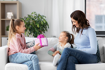 Image showing girl giving present to younger sister at home