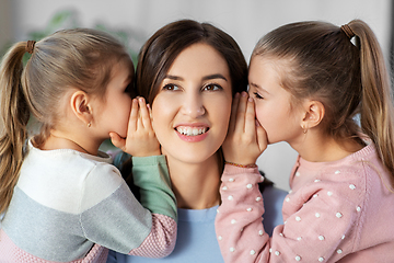 Image showing happy mother and daughters gossiping at home