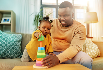 Image showing african family playing with baby daughter at home