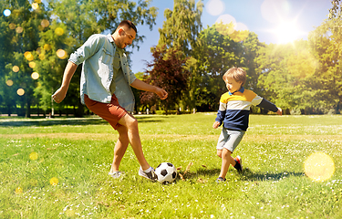 Image showing father with little son playing soccer at park