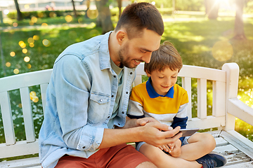 Image showing father and son with smartphone at park