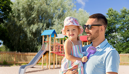 Image showing happy father with little daughter on playground