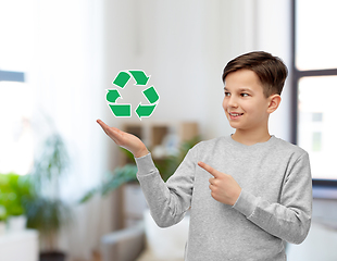 Image showing smiling boy showing green recycling sign