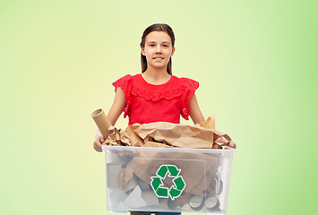 Image showing smiling girl sorting paper waste over green