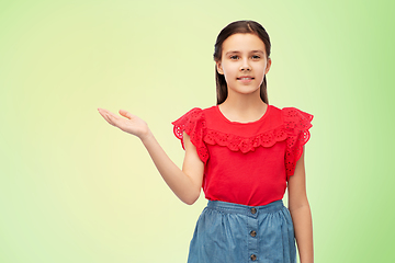 Image showing happy smiling girl holding something on her hand