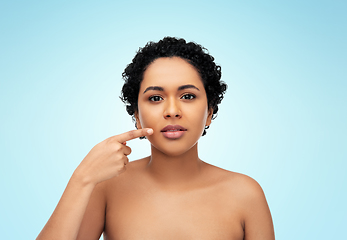 Image showing young african american woman pointing to her lips