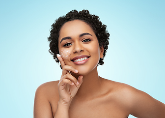 Image showing young african american woman with moisturizer