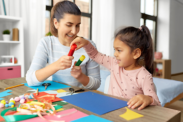 Image showing daughter with mother making applique at home