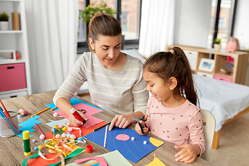 Image showing daughter with mother making applique at home