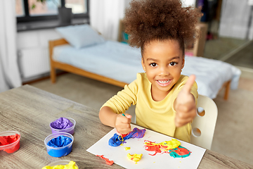 Image showing little girl with modeling clay playing at home