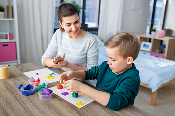 Image showing mother and son playing with modeling clay at home