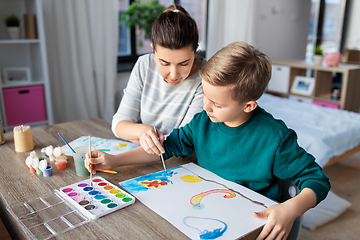 Image showing mother and son with colors drawing at home