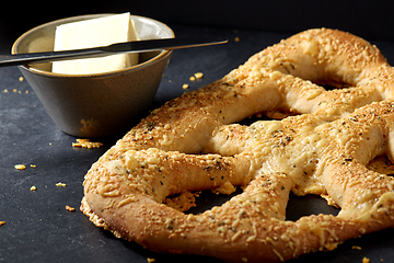 Image showing close up of cheese bread, butter and table knife