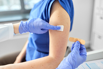 Image showing doctor attaching patch to medical worker