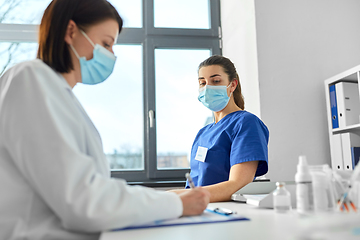 Image showing doctor with clipboard and nurse at hospital