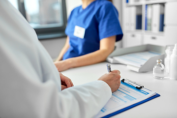 Image showing doctor with clipboard and nurse at hospital